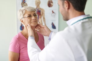 Doctor examining throat